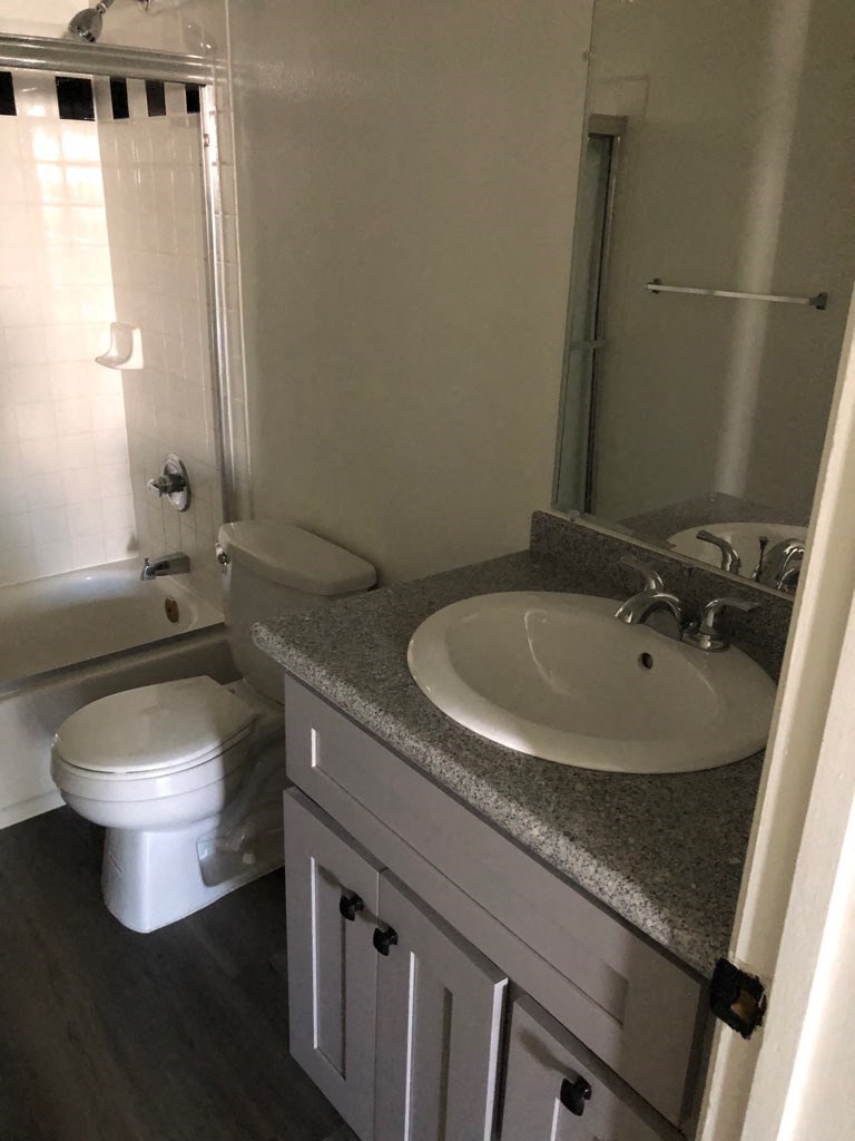 a bathroom with a sink toilet and a mirror