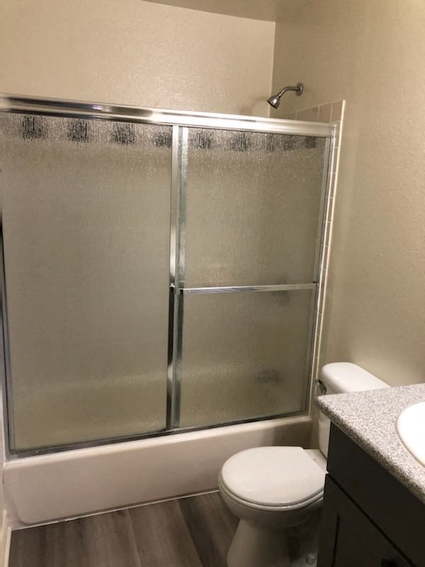 a bathroom with a toilet and a shower