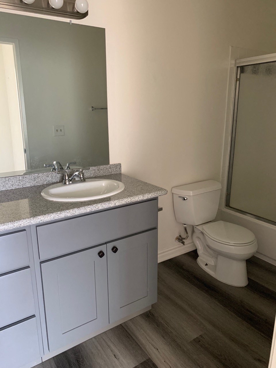 a bathroom with a sink toilet and a mirror