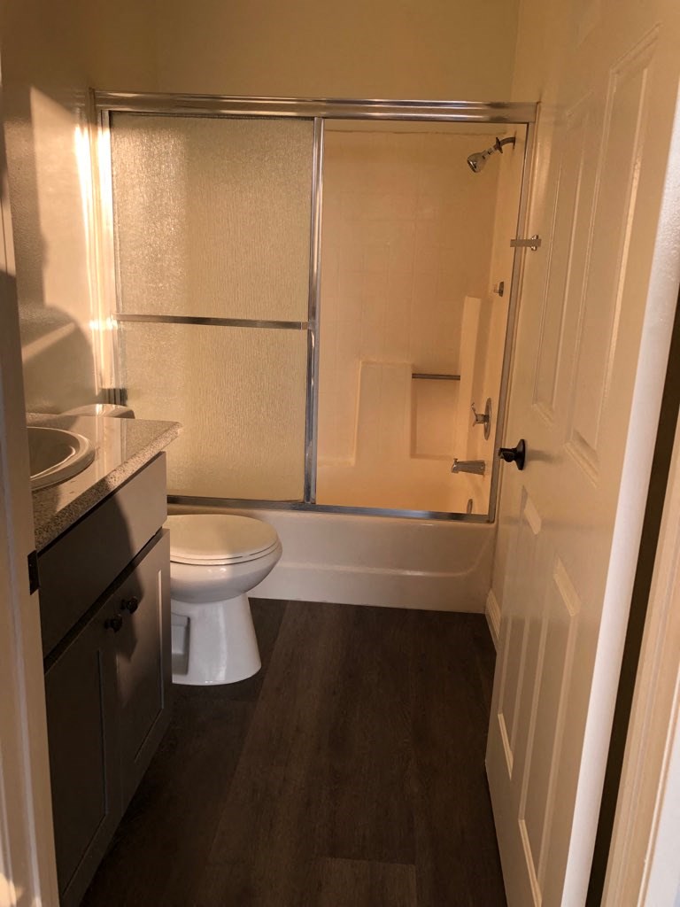 a bathroom with a toilet and a shower