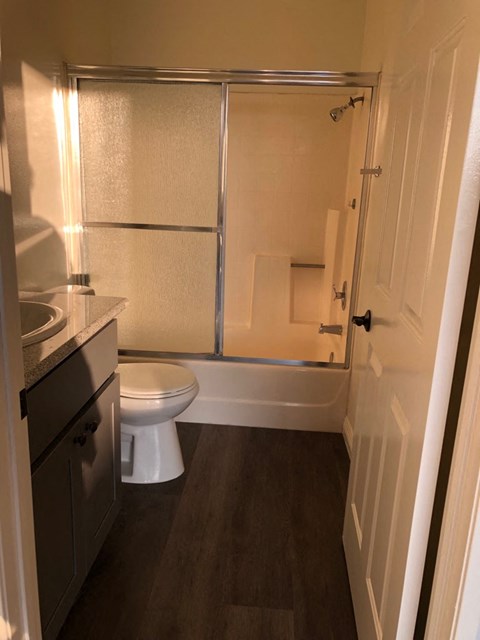a bathroom with a toilet and a shower