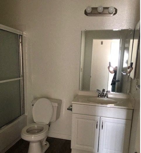 a bathroom with a toilet and a sink and a mirror