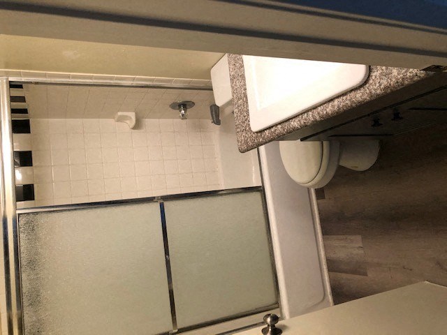 a bathroom with a shower stall and a sink