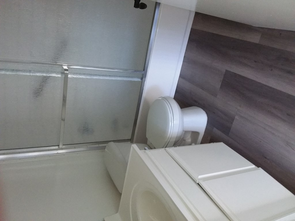 a small bathroom with a toilet and a shower