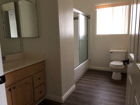 a bathroom with a toilet and a sink and a shower