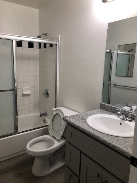a bathroom with a toilet and a sink and a shower