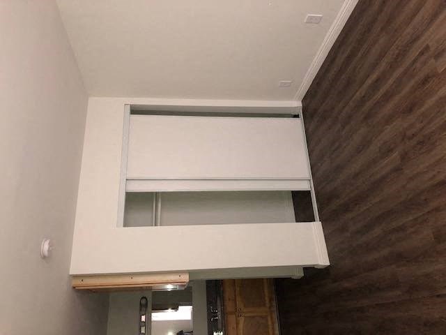 an overhead view of a white loft with a wooden wall