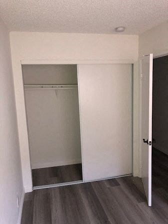 an empty room with a closet and a door