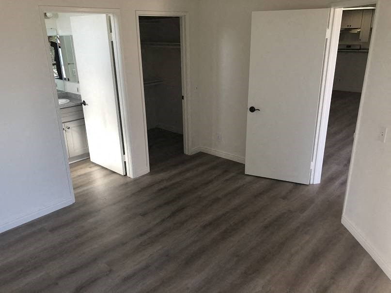 a living room with a wooden floor and a door