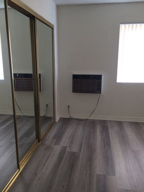 a room with a mirror and a radiator on the wall