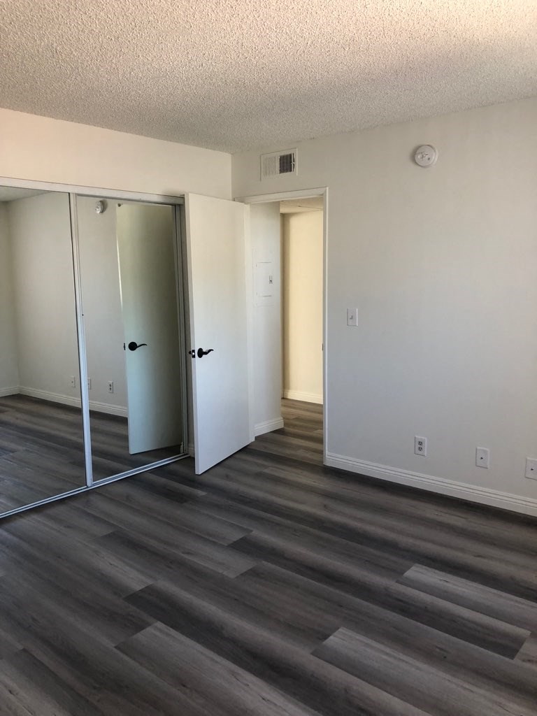 a living room with a mirror and a closet