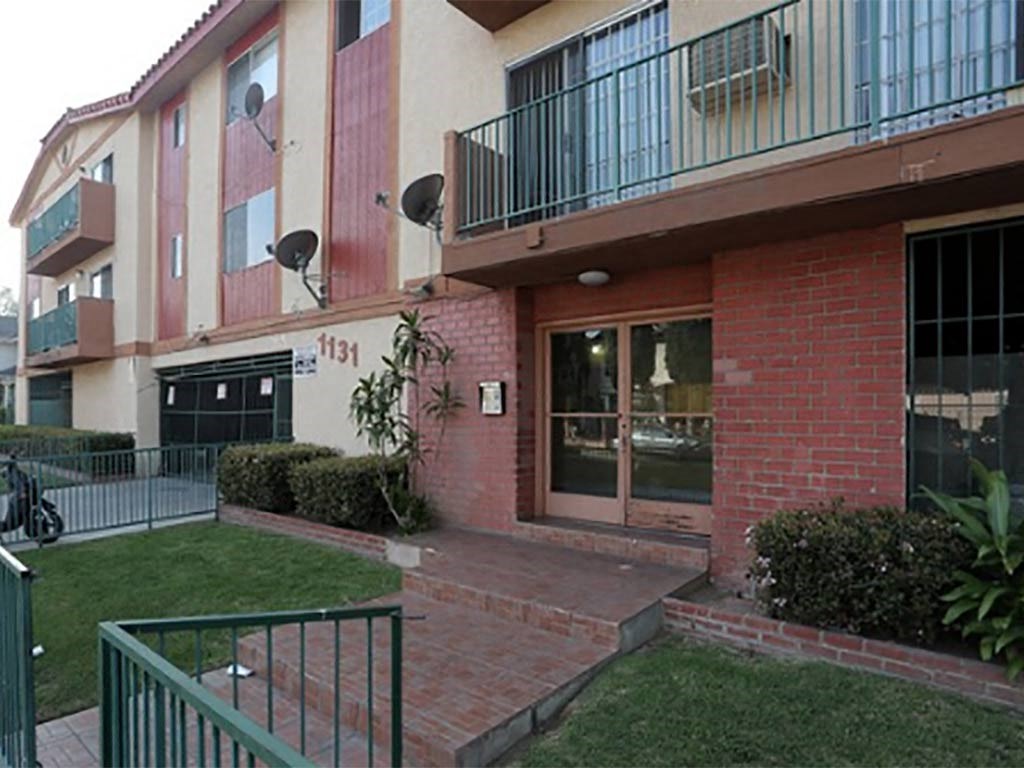 the front entrance of an apartment building