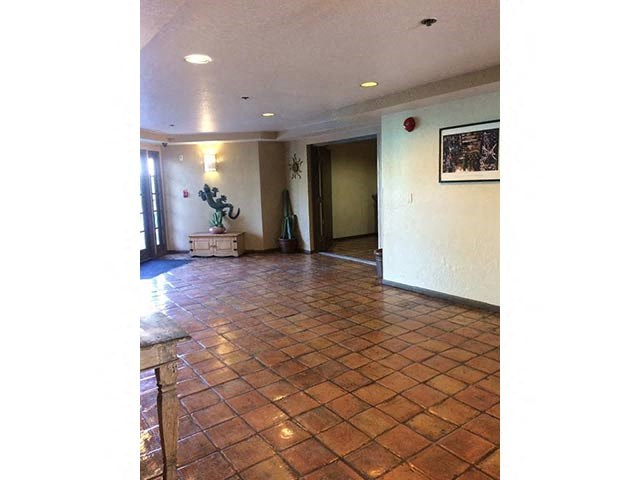 a living room with a tiled floor and a door