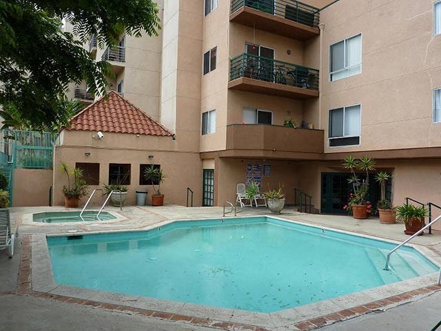a swimming pool in front of an apartment building