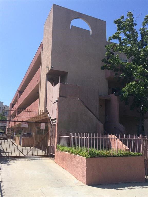 a tall building with a fence and a gate