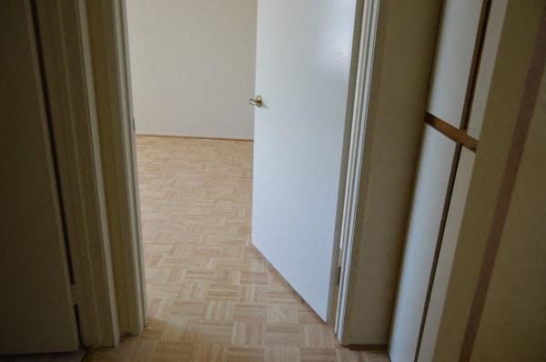 a white door in a room with a wooden floor