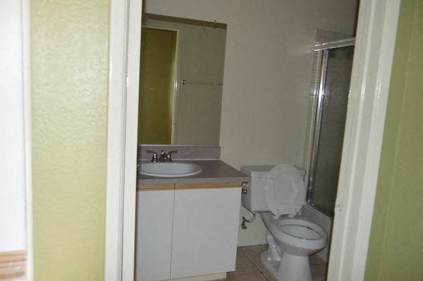 a bathroom with a toilet and a sink and a mirror