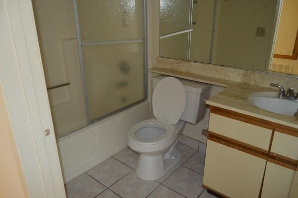 a bathroom with a toilet and a sink and a shower