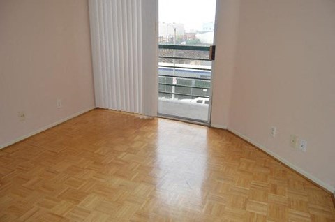 a living room with a window and wooden floors