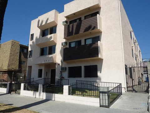 a white building with a black fence in front of it