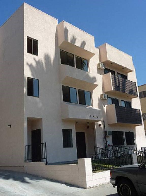 an apartment building with a truck parked in front of it