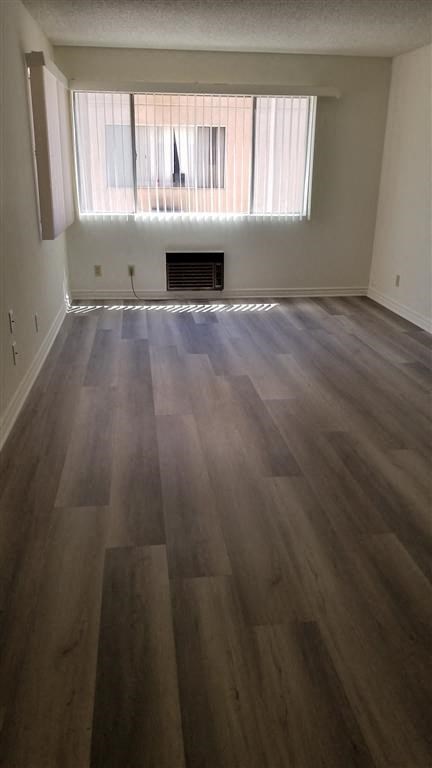 a empty living room with wooden floors and a window