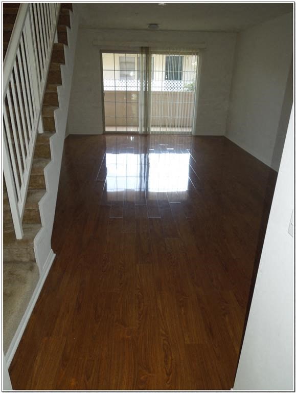 a living room with a hard wood floor and a staircase
