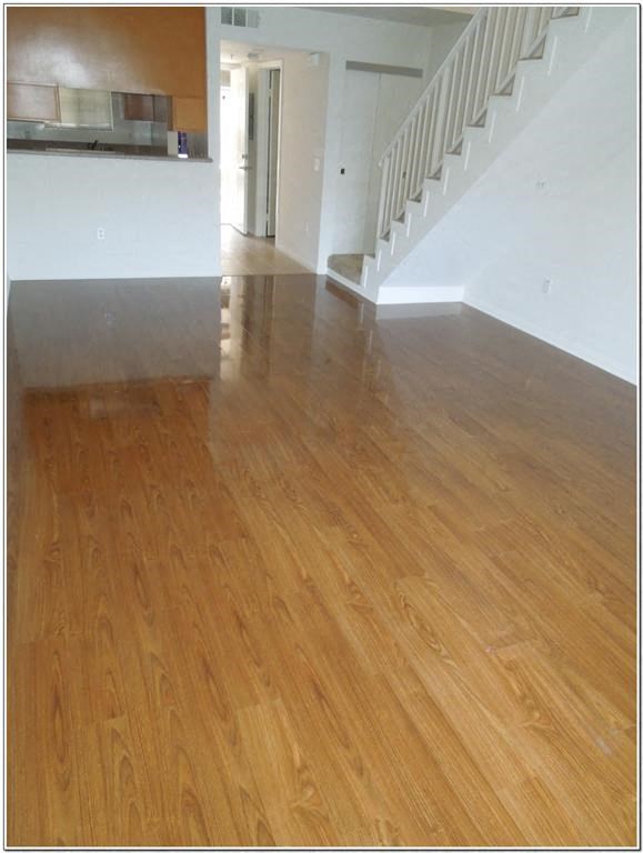 a living room with a hard wood floor and a staircase