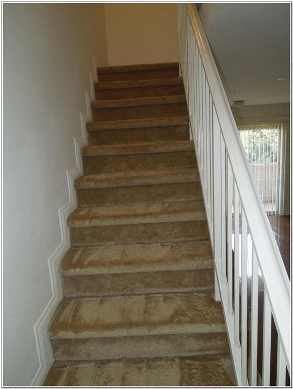 a set of stairs with a white railing and a white staircase