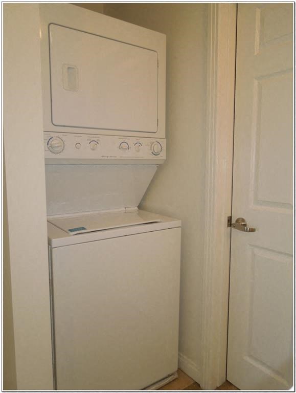 a white washer and dryer in a small closet