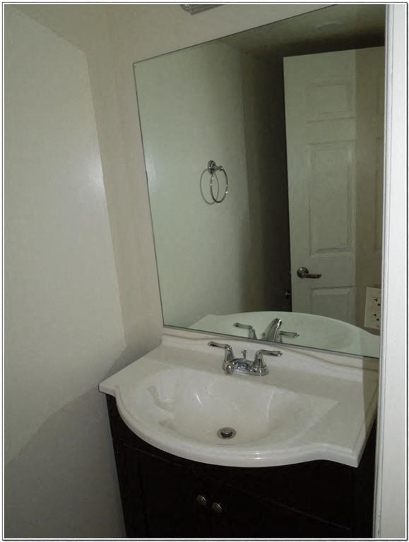 a bathroom with a white sink and a mirror