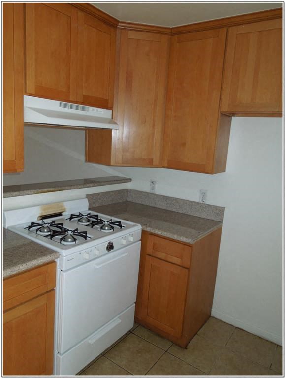 a small kitchen with a stove and a microwave