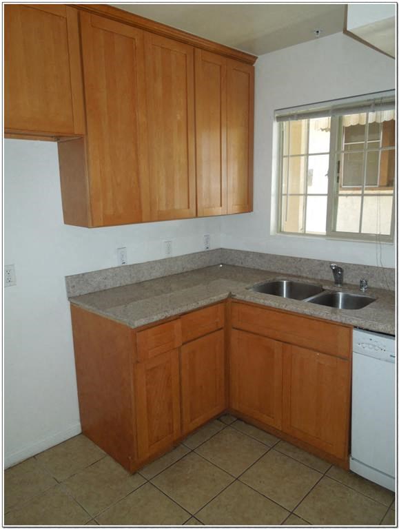 a kitchen with a sink and cabinets and a window