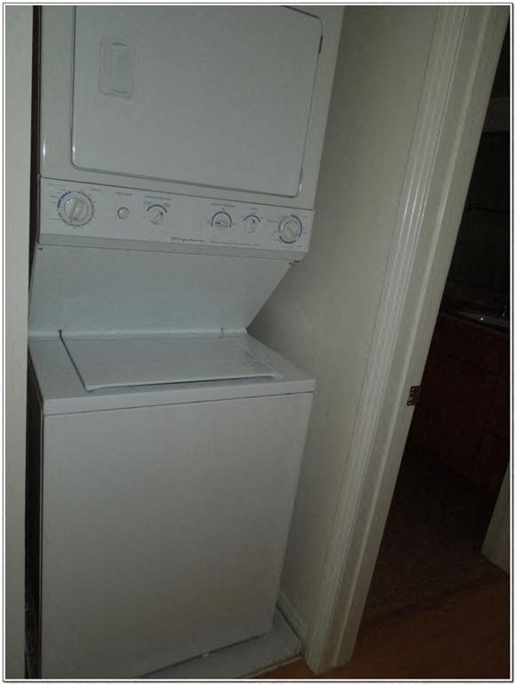 a white washer and dryer in a closet