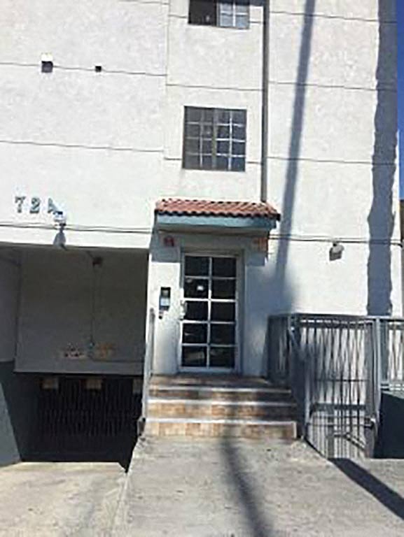 a white building with a door and stairs