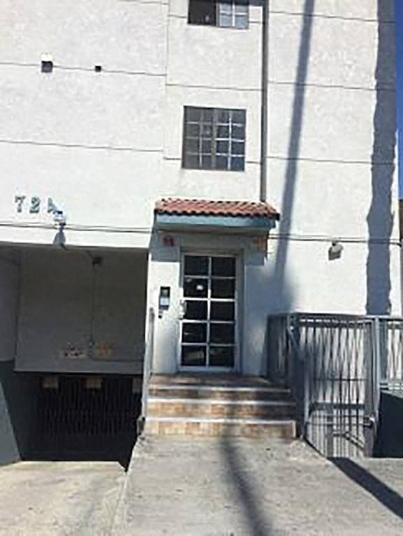 a white building with a door and stairs
