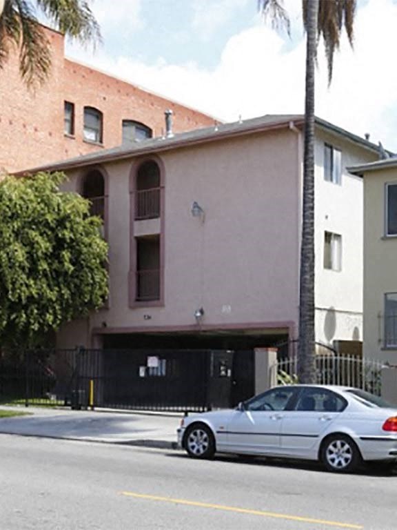 a white car parked in front of a building