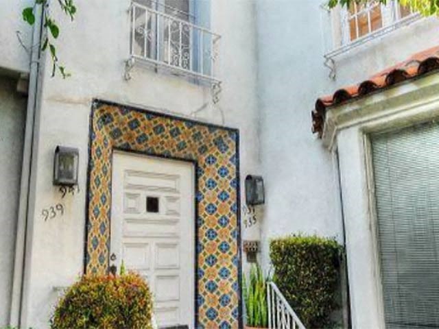 the front of a house with a door and a tiled window