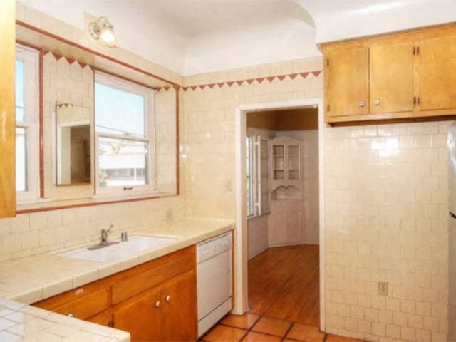 a kitchen with a sink and a mirror