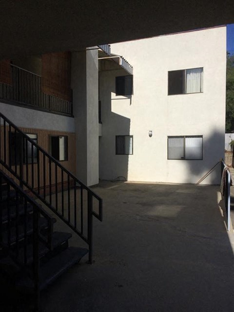 an apartment building with stairs and a courtyard