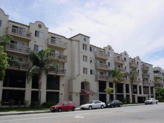 an apartment building with cars parked in front of it