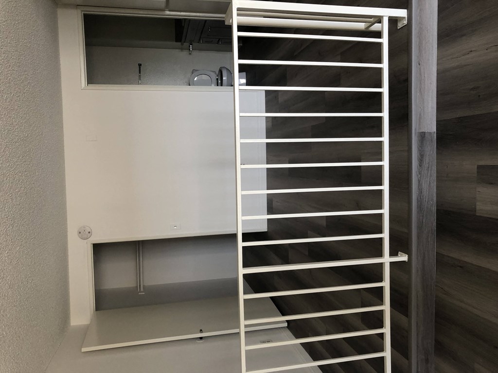 a spiral staircase in a room with a wall and a door