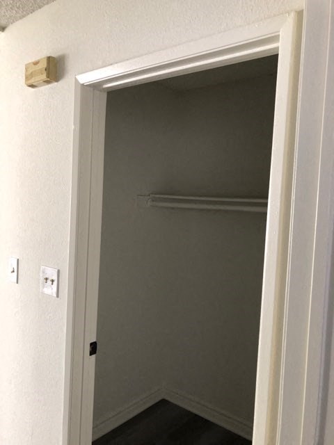 an open door to a bathroom with a closet