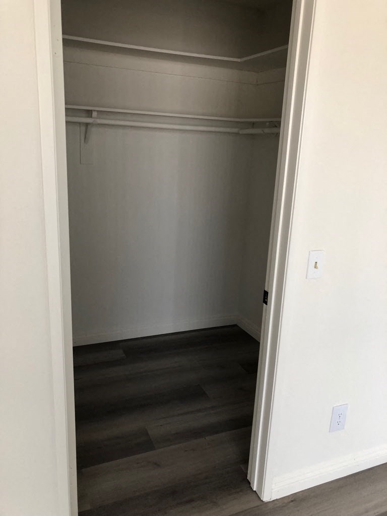 a room with a closet and a wood floor
