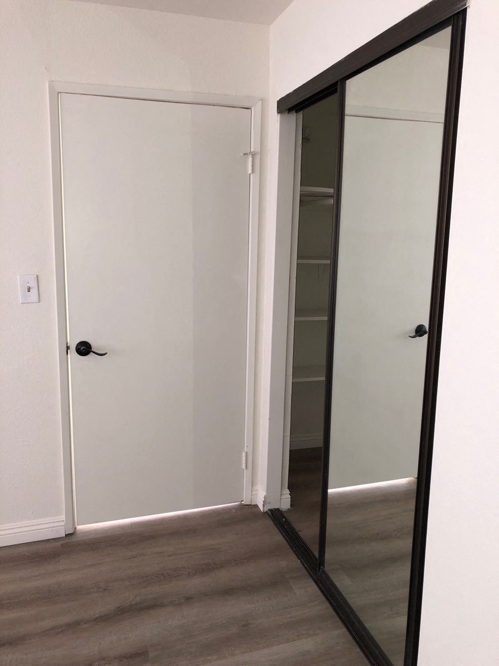 a room with a mirror and a closet