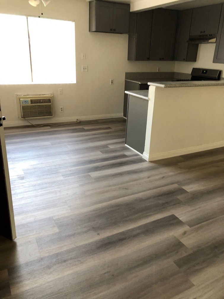 a renovated kitchen with wood flooring in a house