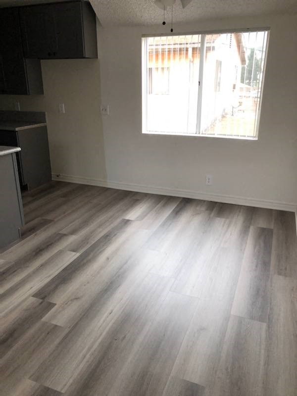 a living room with a hard wood floor and a window