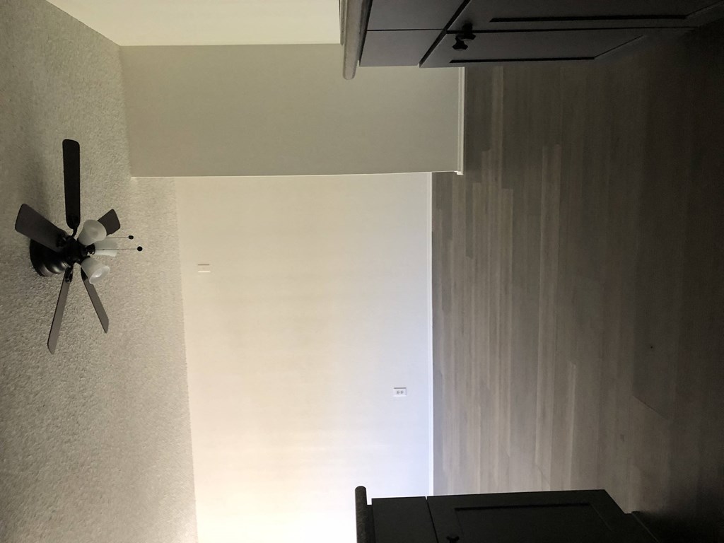 a ceiling fan hanging on a wall in a room