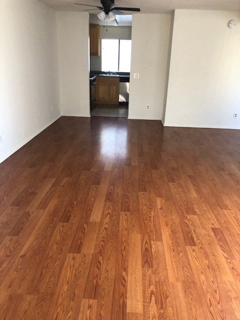 an empty living room with a wooden floor