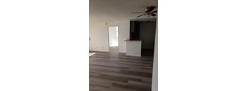 A room with a ceiling fan and a cabinet.